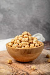Hazelnuts on wood background. Roasted hazelnuts in a bowl