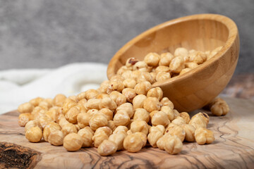 Hazelnuts on wood background. Roasted hazelnuts in a bowl. Close up