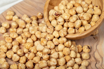 Hazelnuts on wood background. Roasted hazelnuts in a bowl. Close up