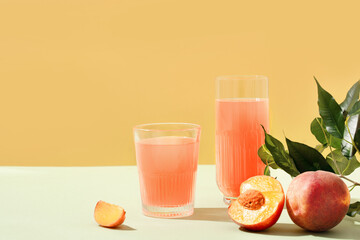 Cocktail or mocktail in glass and fruit peach half and whole