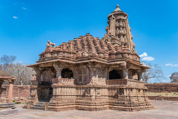 Ancient Indian Menal Shiv Temple featuring intricate carvings and vibrant floral foreground, Rajasthan, India