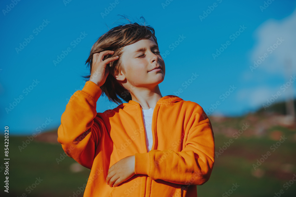 Canvas Prints Outdoors portrait of handsome boy combing his hair with his hand