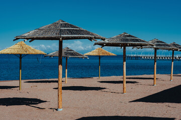 Umbrellas on sea beach on summer day
