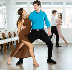 Guy is professional dancer and teacher focused on his female partner, teaching her to perform...