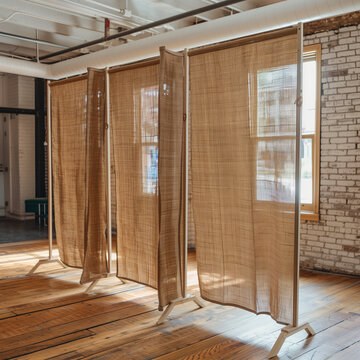 Rustic Burlap Room Dividers Offer Functional Style in a Studio
