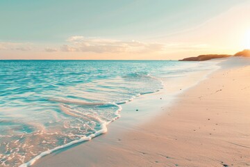 Turquoise ocean water gently lapping a secluded sandy beach at sunset