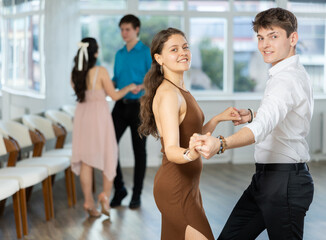 While doing rehearsal of reporting concert, guy and girl participants of dance workshop perform...