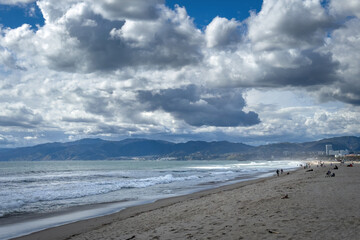 Scenic view of Venice Beach, Los Angeles, California, USA against Santa Monica mountains and blue sky with clouds