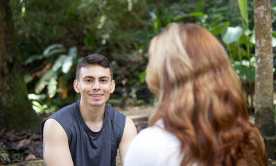 Fototapeta premium man in sportswear sitting in a park looking at the camera