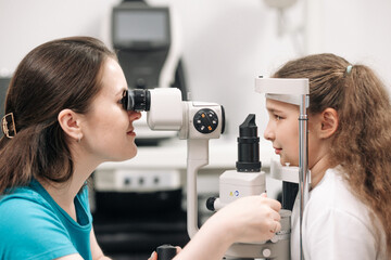 Examination of the child using a slit lamp. Microscope and focused light source. A device for...