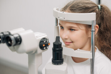 Examination of the child using a slit lamp. Microscope and focused light source. A device for...