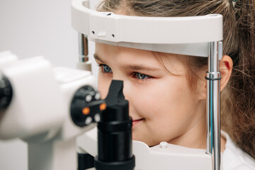 Examination of the child using a slit lamp. Microscope and focused light source. A device for...