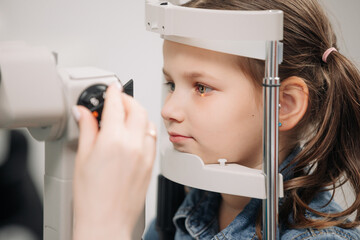 Examination of the child using a slit lamp. Microscope and focused light source. A device for...