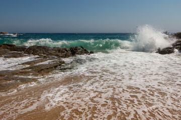 beach in Cala Sa Boadella Bay, Costa Brava, Lloret de Mar, Catalonia, Spain. Beautiful seascape. huge waves