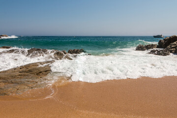 beach in Cala Sa Boadella Bay, Costa Brava, Lloret de Mar, Catalonia, Spain. Beautiful seascape. huge waves