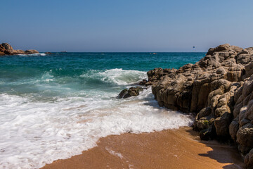 beach in Cala Sa Boadella Bay, Costa Brava, Lloret de Mar, Catalonia, Spain. Beautiful seascape. huge waves