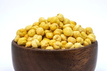 Closeup of Roasted Garbanzo Bean or Chickpea in a Wooden Bowl Isolated on White Background with Copy Space, Also Known as Bengal Gram or Egyptian Pea