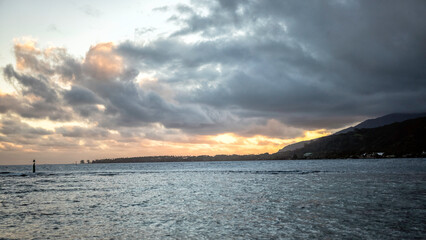 Colorful Sunrise in Bora Bora with sun and clouds shining over Pacific Ocean in French Polynesia