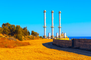 Industrial landscape with chimneys of power plant in sunny day