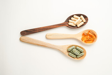 Vitamin capsules in a wooden spoon, soft gels, Fish oil capsules, omega 3, omega 9, vitamin D,...