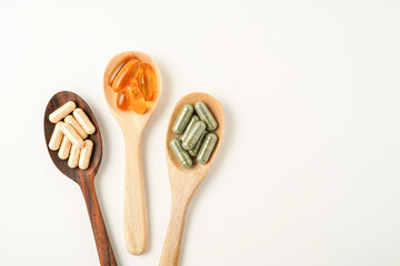 Vitamin capsules in a wooden spoon, soft gels, Fish oil capsules, omega 3, omega 9, vitamin D, vitamin E