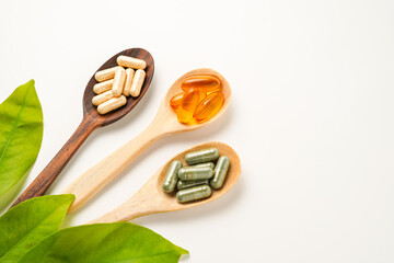 Vitamin capsules in a wooden spoon, soft gels, Fish oil capsules, omega 3, omega 9, vitamin D, vitamin E