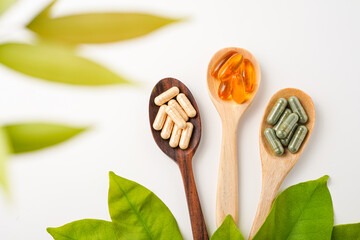 Vitamin capsules in a wooden spoon, soft gels, Fish oil capsules, omega 3, omega 9, vitamin D, vitamin E
