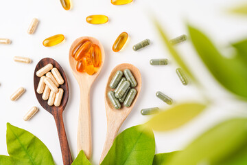 Vitamin capsules in a wooden spoon, soft gels, Fish oil capsules, omega 3, omega 9, vitamin D,...