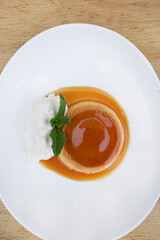 Traditional gourmet dessert. Top view of a flan with cream and caramel.