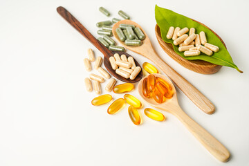 Vitamin capsules in a wooden spoon, soft gels, Fish oil capsules, omega 3, omega 9, vitamin D,...