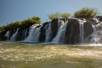 Majestic view of the Mocona falls. The Moconá waterfalls, river and rocky cliffs in a summer sunny...