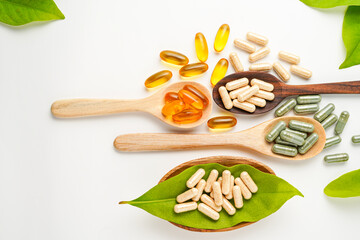 Vitamin capsules in a wooden spoon, soft gels, Fish oil capsules, omega 3, omega 9, vitamin D,...