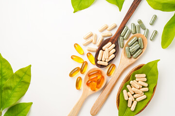 Vitamin capsules in a wooden spoon, soft gels, Fish oil capsules, omega 3, omega 9, vitamin D,...