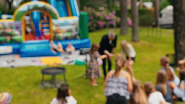 Enjoy slow motion kids outdoor playground fun with a bounce house in a lively and cheerful atmosphere