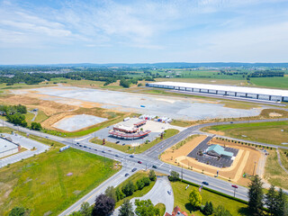 Fototapeta premium Areial drone view of business park with gas station and warehouse. 