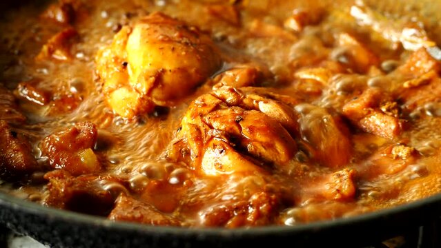 Stewing chicken with sauce in pan,  in door Chiangmai Thailand.