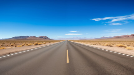 Straight Road Through Vast Desert Under Clear Blue Sky