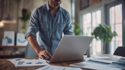 portrait of a man working with business documents with a laptop on the table in modern office, business analysis research 