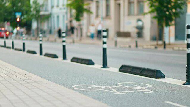 A setup for urban biking, with a slow motion lane divider and safety bollards for cyclist protection