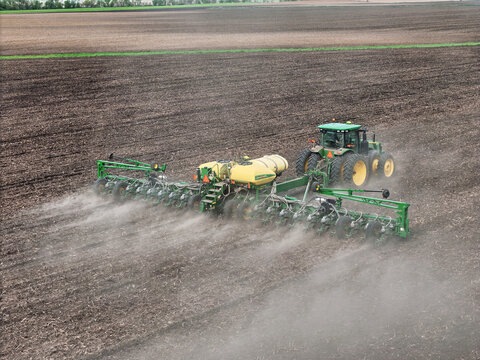 Brodhead, Wisconsin - May 1. 2024:  John Deere 8370R tractor pulling a John Deere 1775NT planter