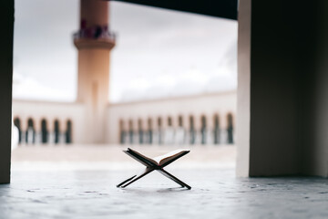 Islamic concept - The Holy Al Quran at beautiful mosque with written Arabic calligraphy meaning of...