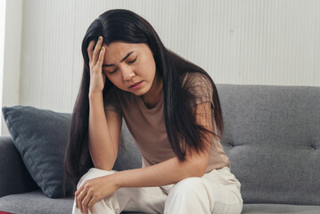 Recession Stress Woman work hard at home office headache depressed failure business burnout sitting on sofa. Tired Asian woman despair stress overworked frustration pain panic depression life crisis