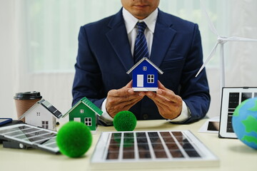 Businessman signs a contract for car insurance in an eco-friendly office. This agreement emphasizes renewable energy and green technology, commitment to clean power and environmental responsibility.