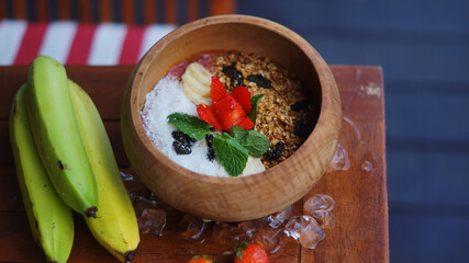 banana smoothie bowl with strawberry and coconut toppings