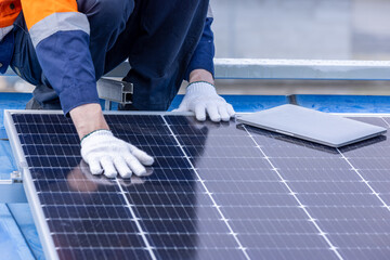 Male professional engineer installing solar photovoltaic panel system, Electrician mounting blue...