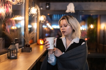 Portrait of a young beautiful blonde girl in an evening spring city.