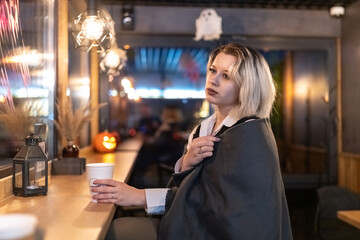 Portrait of a young beautiful blonde girl in an evening spring city.