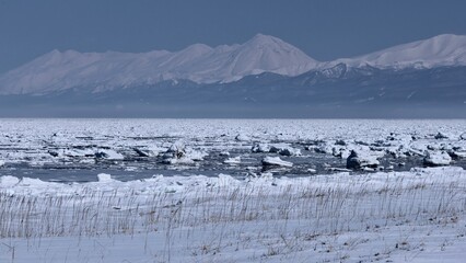 Naklejka premium winter landscape with Shiretoko Mountain Range and ice floe in Hokkaido, Japan
