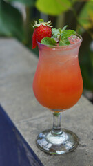 cocktail with mint leaves and strawberry garnish