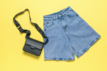 Summer Fashion Essentials: Denim Shorts and Crossbody Bag on Yellow Background